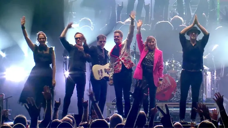 New Moon on Monday Duran Duran tribute band members waving to the crowd at the end of a show