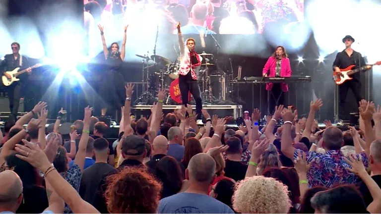 New Moon on Monday Duran Duran tribute on stage as a packed crowd raises their hands